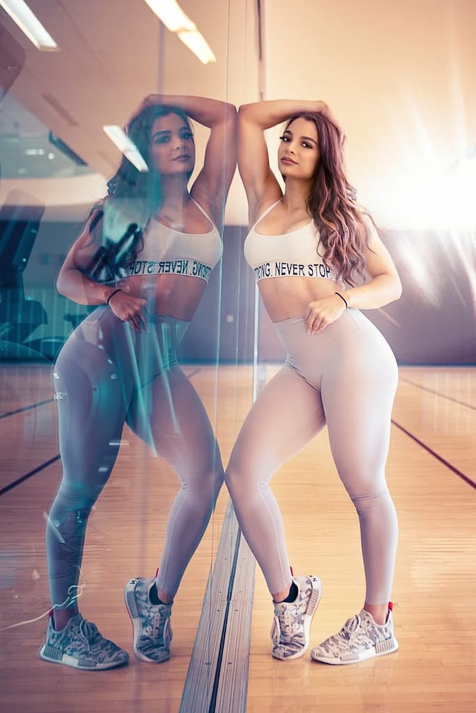 Slimming Tonic: 2024 Ultimate Solution to Stubborn Belly Fat in Weight Loss reflection of woman leaning on mirror wall